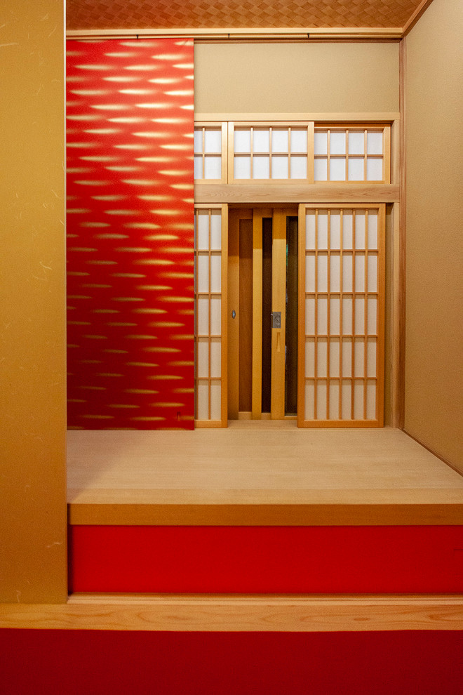 Mid-sized asian guest bedroom in Other with red walls, tatami floors, no fireplace and red floor.