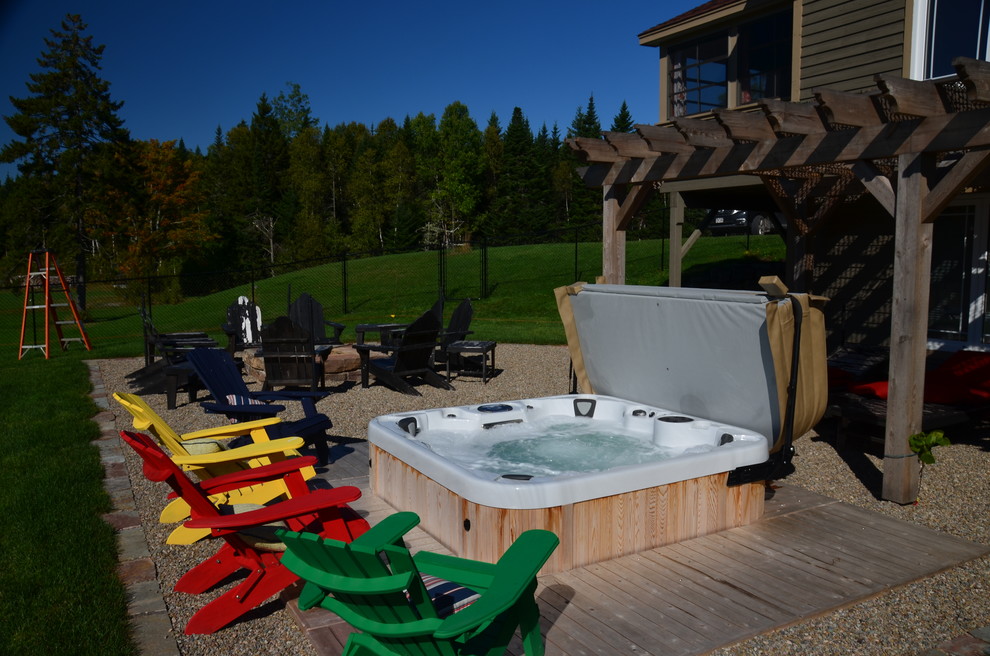 Inspiration for a large rustic backyard stamped concrete and rectangular pool remodel