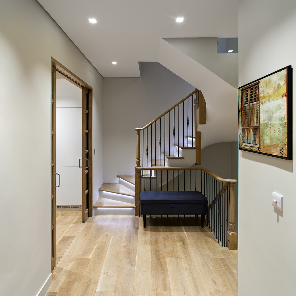 Design ideas for a traditional wood staircase in London with painted wood risers.