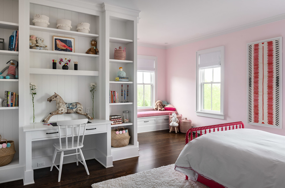Photo of a mid-sized country kids' bedroom for kids 4-10 years old in New York with pink walls, dark hardwood floors and brown floor.