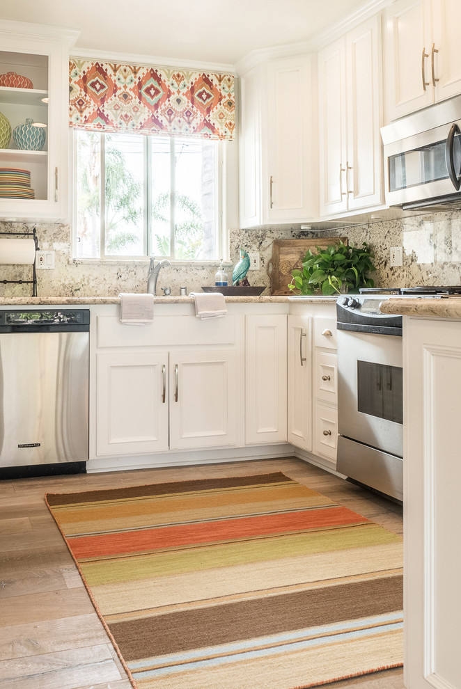Inspiration for a small eclectic u-shaped separate kitchen in San Diego with an undermount sink, recessed-panel cabinets, white cabinets, granite benchtops, beige splashback, stainless steel appliances, medium hardwood floors and a peninsula.