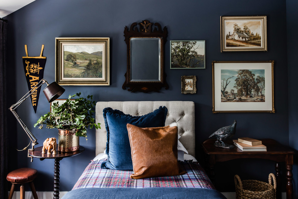 This is an example of a large eclectic bedroom in Sydney with blue walls and dark hardwood floors.