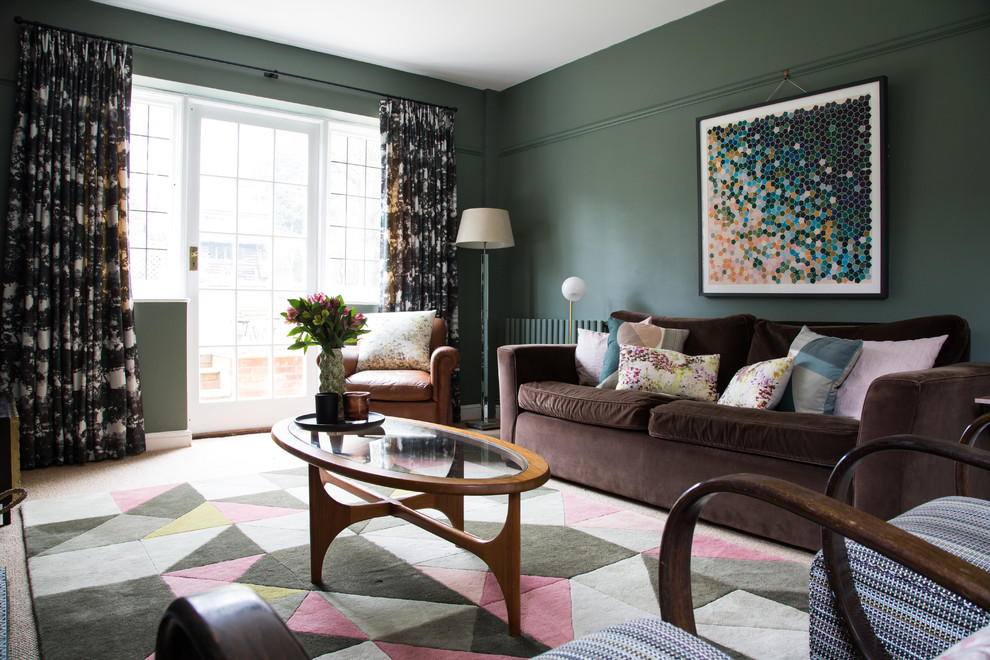 Inspiration for a transitional living room in Kent with green walls.