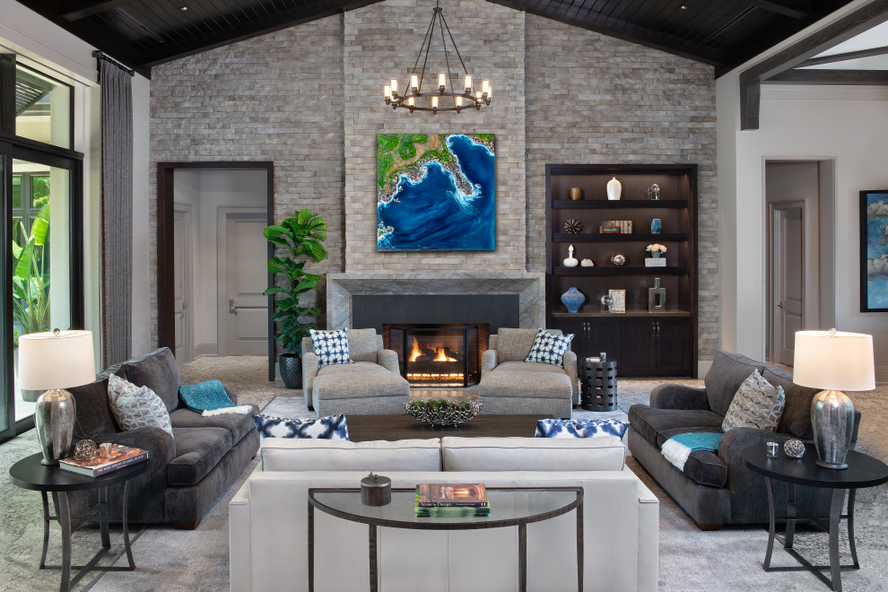This is an example of a world-inspired living room in Other with carpet, a standard fireplace, a stone fireplace surround and a timber clad ceiling.