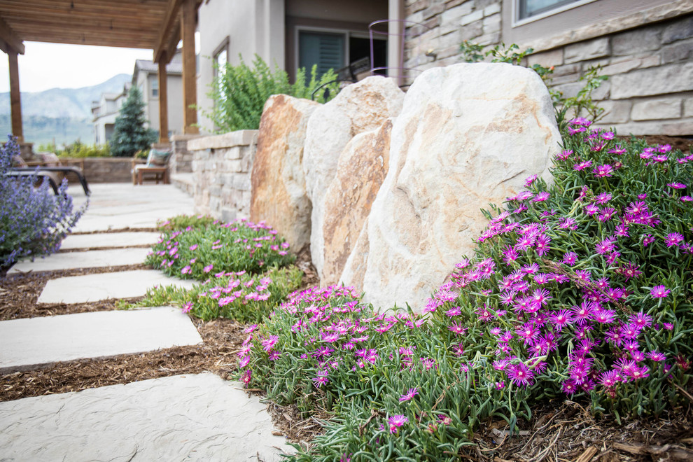 Mid-sized contemporary backyard full sun xeriscape in Denver with natural stone pavers and a fire feature for summer.