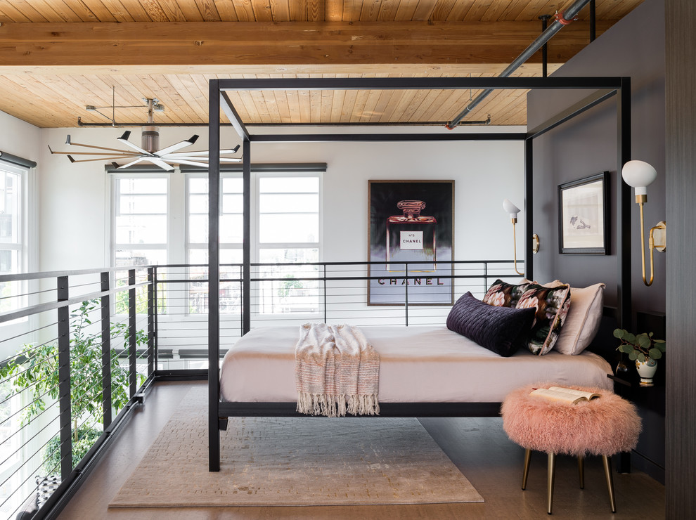 This is an example of a contemporary loft-style bedroom in Seattle with black walls, concrete floors and grey floor.
