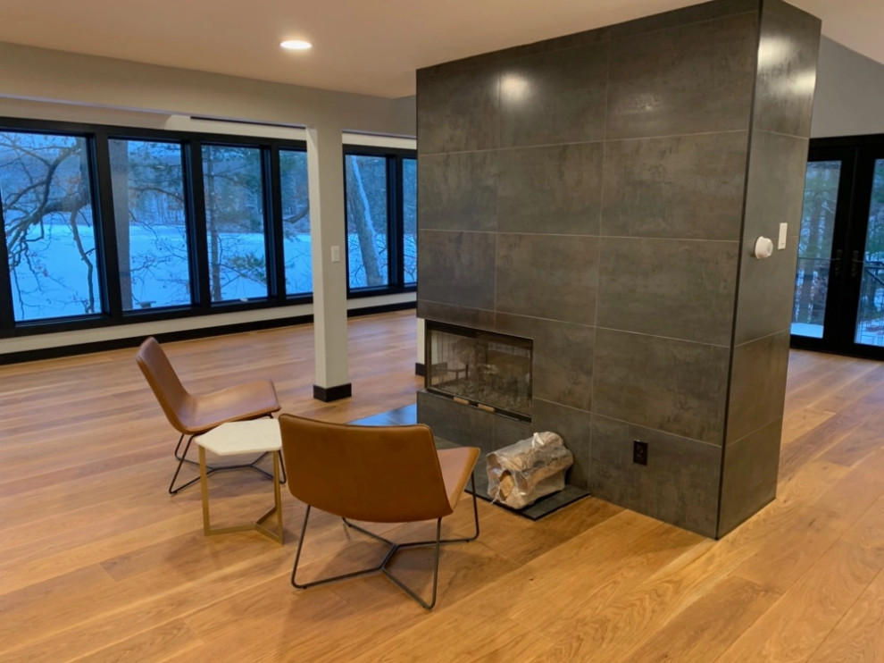 Example of a trendy open concept medium tone wood floor living room design in Boston