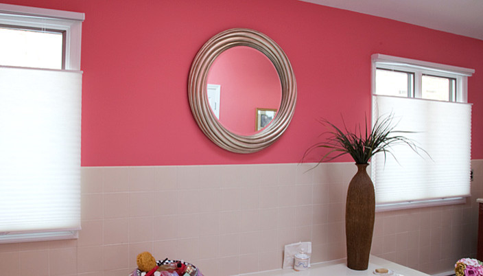 Large contemporary master bathroom in New York with tile benchtops, white tile, ceramic tile and pink walls.
