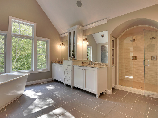 Design ideas for a large transitional master bathroom in Minneapolis with an undermount sink, shaker cabinets, white cabinets, engineered quartz benchtops, a freestanding tub, a double shower, a one-piece toilet, yellow tile, subway tile, green walls and porcelain floors.