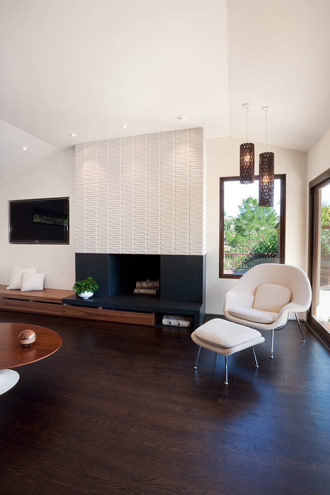 Midcentury open concept living room in San Francisco with a tile fireplace surround, beige walls, dark hardwood floors, a standard fireplace and brown floor.
