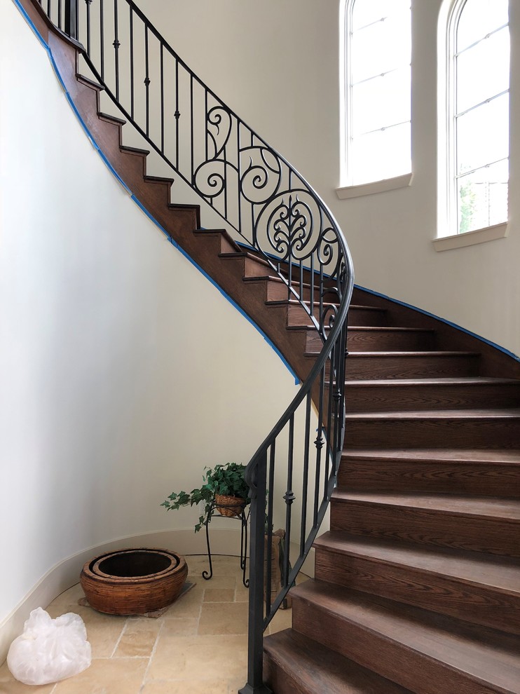 Design ideas for a large mediterranean curved staircase in Houston with metal railing.