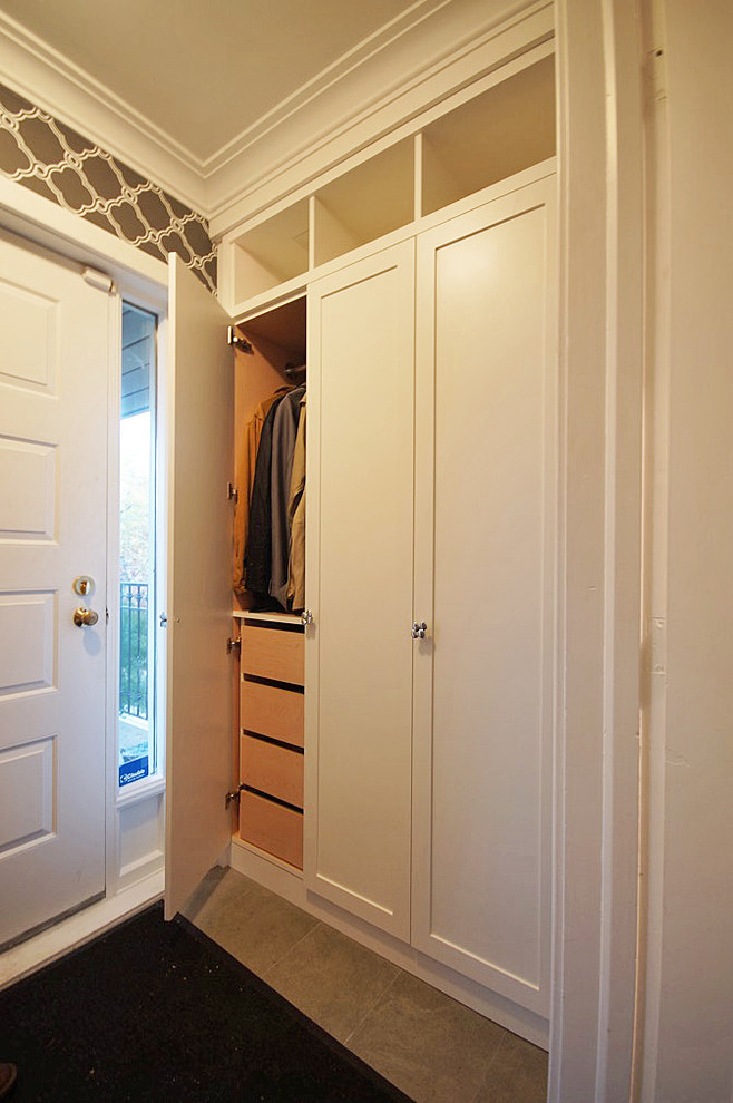 This is an example of a mid-sized contemporary mudroom in Toronto with brown walls, porcelain floors, a single front door and a white front door.