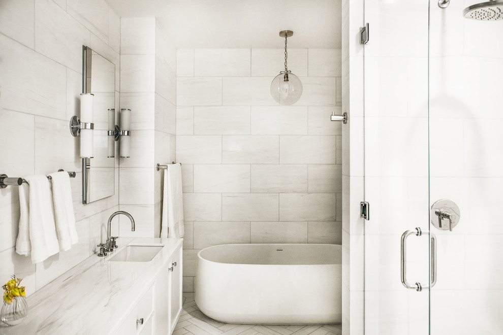 Inspiration for a large contemporary master bathroom with flat-panel cabinets, white cabinets, a freestanding tub, an alcove shower, a one-piece toilet, white tile, marble, white walls, marble floors, an undermount sink, marble benchtops, white floor, a hinged shower door and white benchtops.