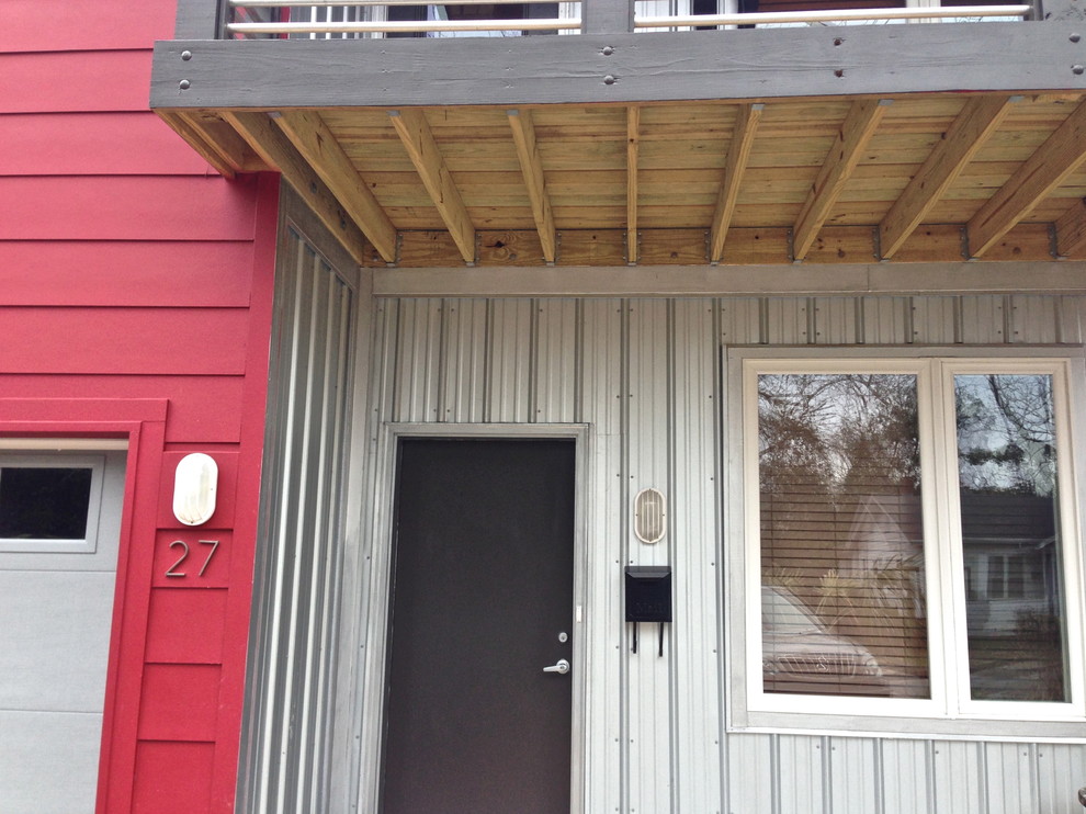This is an example of a mid-sized modern two-storey red townhouse exterior in Wilmington with metal siding.