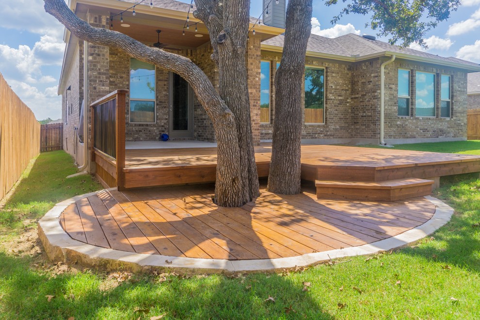 Example of a mid-sized transitional backyard home design design in Austin with a roof extension