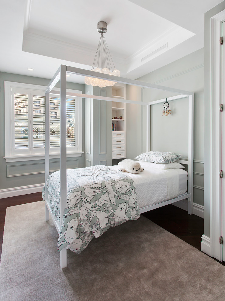 Photo of a transitional bedroom in New York with grey walls and dark hardwood floors.