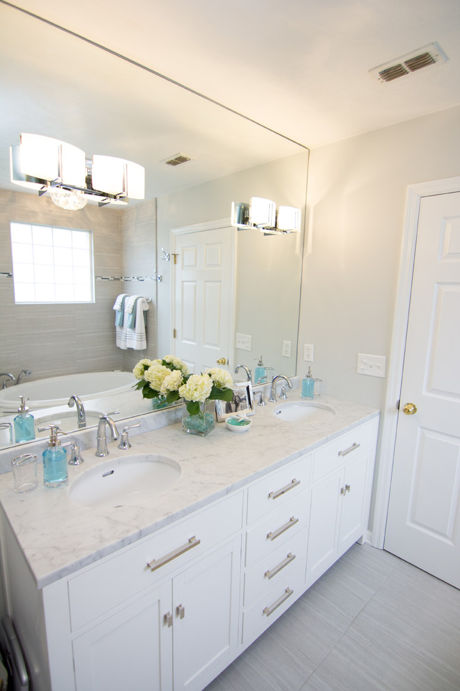 Inspiration for a mid-sized contemporary master bathroom in Atlanta with an undermount sink, shaker cabinets, white cabinets, an alcove tub, a corner shower, a one-piece toilet, gray tile and grey walls.