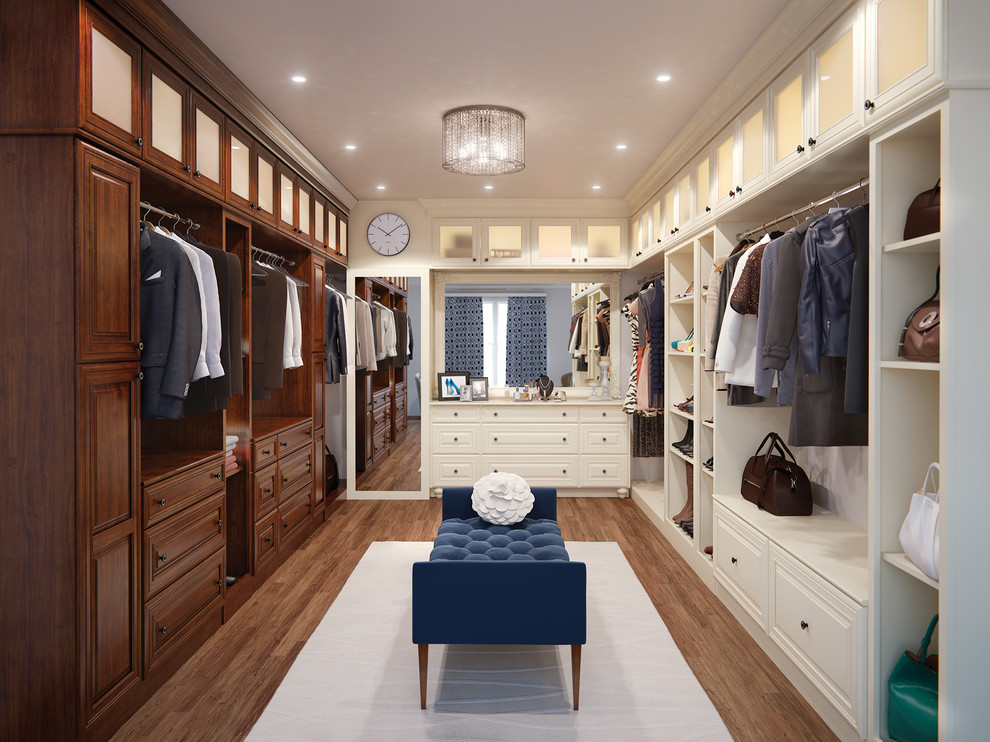 Photo of a traditional gender-neutral dressing room in Other with raised-panel cabinets, dark wood cabinets, medium hardwood floors and brown floor.