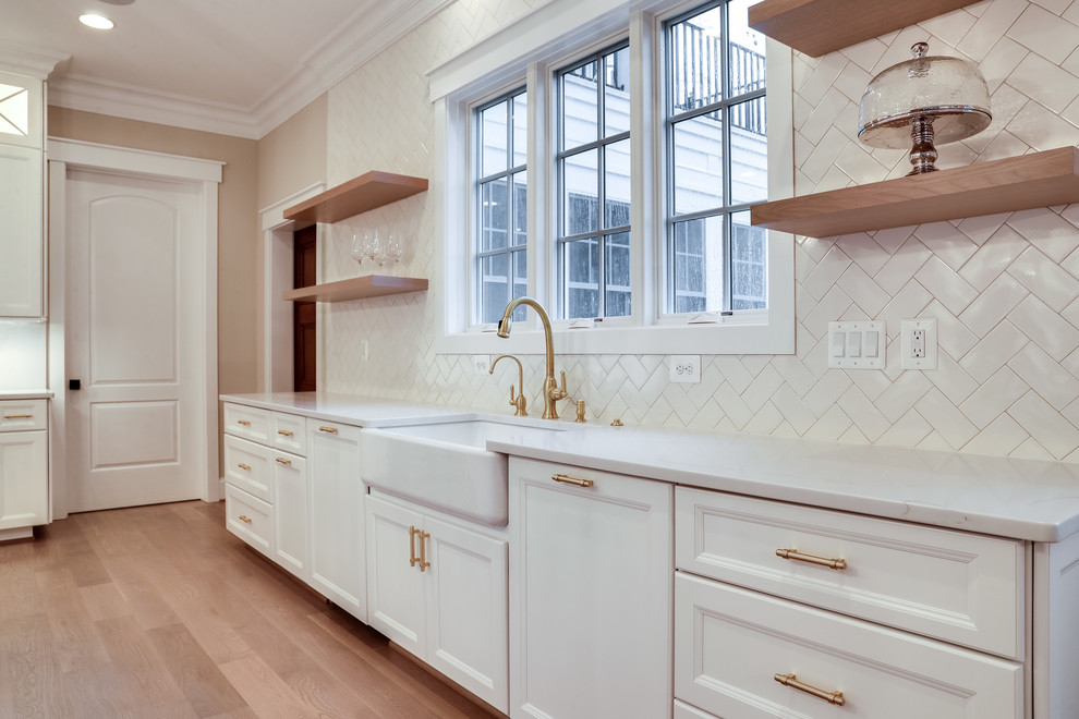 Example of a huge transitional kitchen design in Baltimore with flat-panel cabinets, white cabinets, marble countertops, white backsplash, subway tile backsplash, stainless steel appliances and an island