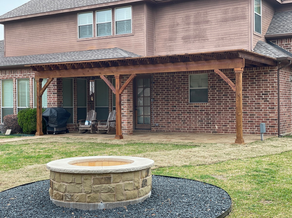 Inspiration for an expansive rustic back patio in Dallas with a fire feature, stamped concrete and a gazebo.
