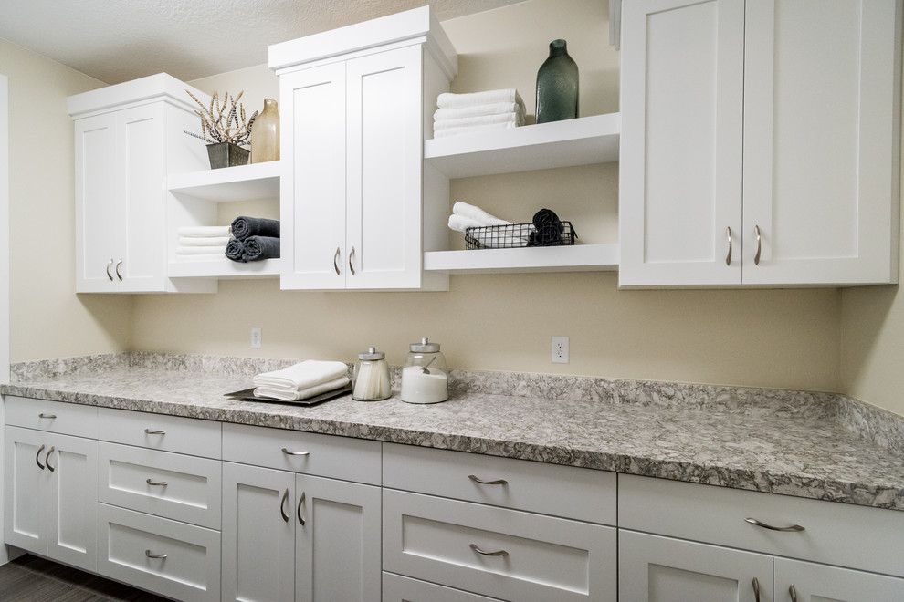 Design ideas for a mid-sized contemporary dedicated laundry room in Salt Lake City with shaker cabinets, white cabinets, granite benchtops, beige walls, vinyl floors and a side-by-side washer and dryer.