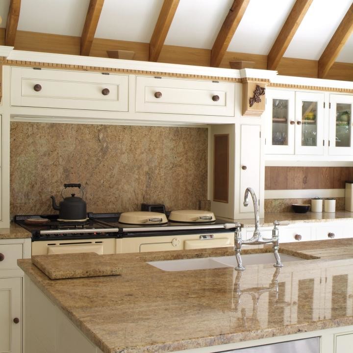 Design ideas for a large country galley eat-in kitchen in London with a double-bowl sink, louvered cabinets, beige cabinets, granite benchtops, brown splashback, stone tile splashback, stainless steel appliances, ceramic floors and with island.