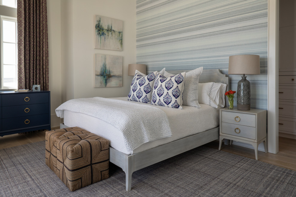Design ideas for a large coastal guest bedroom in Other with blue walls, light hardwood flooring, beige floors and wallpapered walls.