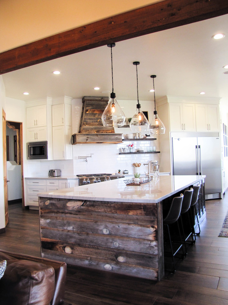 Inspiration for a large transitional porcelain tile and brown floor kitchen remodel in Phoenix with white backsplash, subway tile backsplash, stainless steel appliances and an island