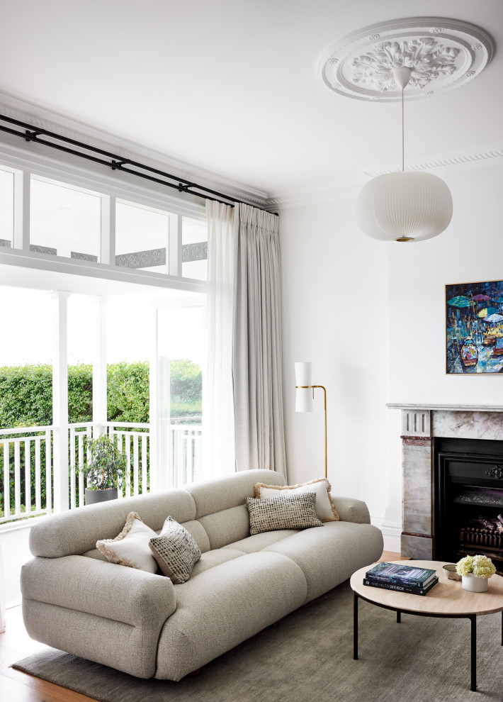 Example of a transitional living room design in Sydney