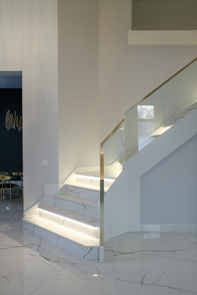 Medium sized contemporary l-shaped metal railing staircase in Chicago with marble treads and marble risers.