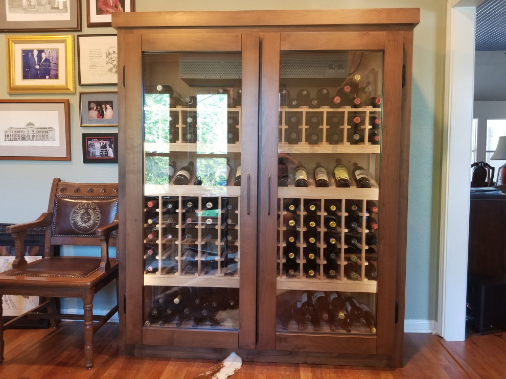This is an example of a mid-sized traditional wine cellar in Austin.