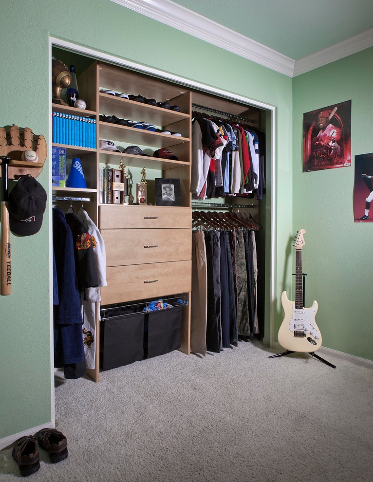 Photo of a small transitional men's built-in wardrobe in Phoenix with flat-panel cabinets, light wood cabinets and carpet.