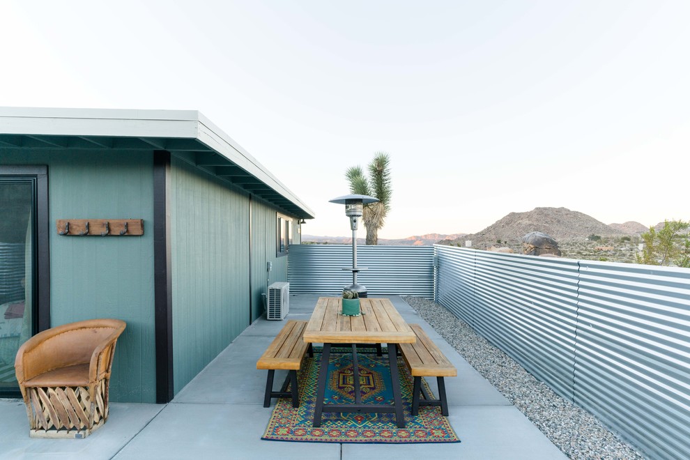 Design ideas for a large eclectic side yard patio in Other with concrete slab and no cover.