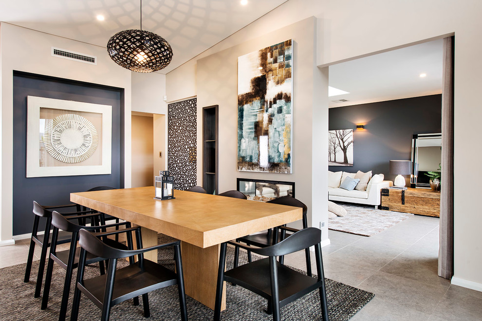 Contemporary dining room in Perth with beige walls and a two-sided fireplace.