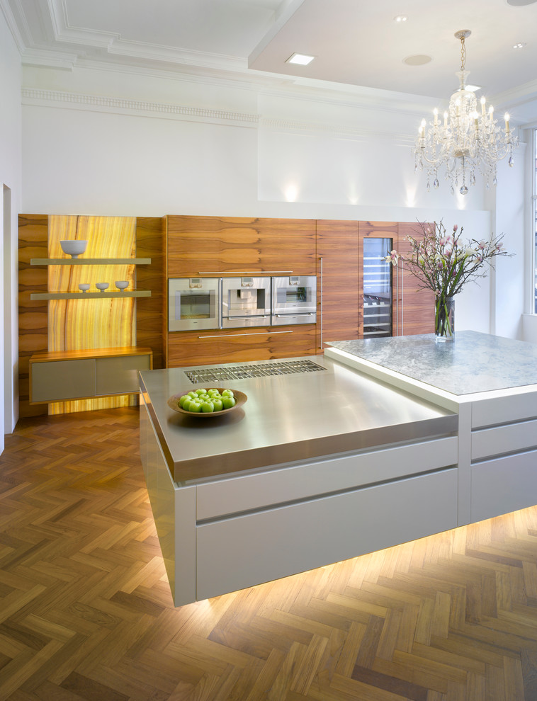 Inspiration for a large contemporary open plan kitchen in London with flat-panel cabinets, medium wood cabinets, quartzite benchtops, medium hardwood floors and with island.