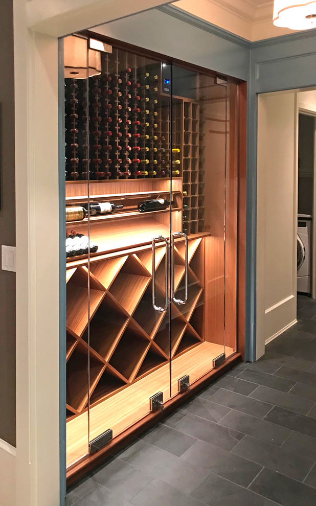 Photo of a small contemporary wine cellar in Chicago with slate floors, display racks and grey floor.