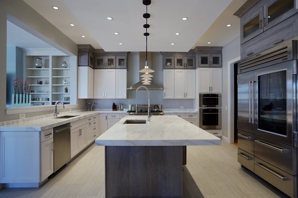 This is an example of a large contemporary kitchen in DC Metro with shaker cabinets, distressed cabinets, marble benchtops, stainless steel appliances, porcelain floors, with island and grey floor.