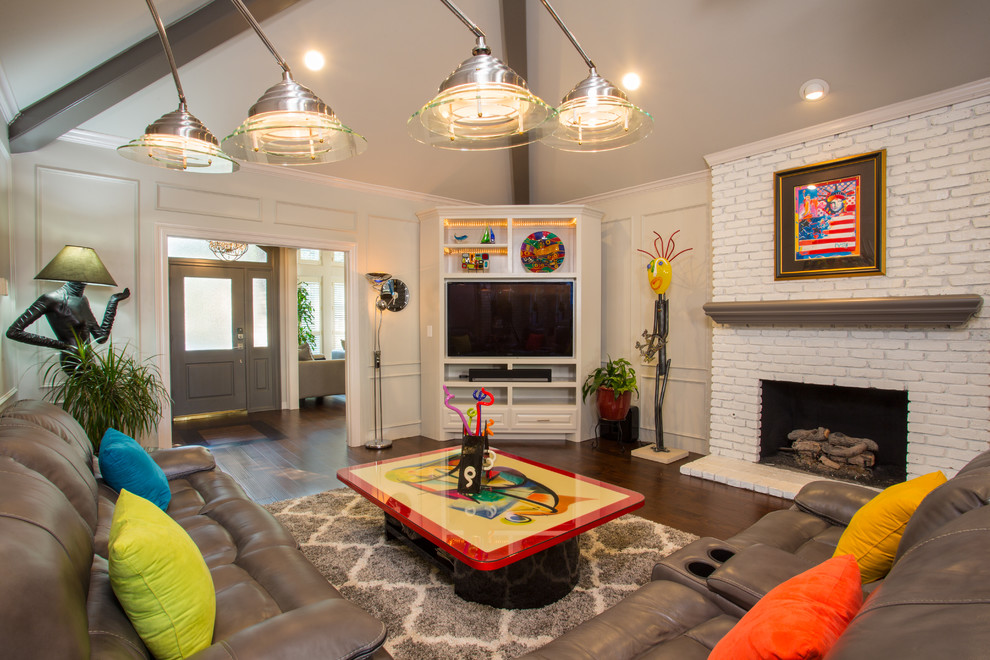 Photo of a mid-sized eclectic enclosed family room in Dallas with beige walls, a standard fireplace, a brick fireplace surround, brown floor, dark hardwood floors and a built-in media wall.