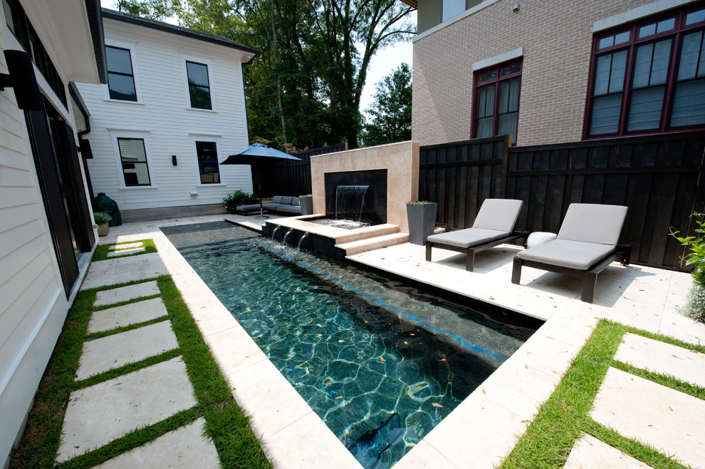 Design ideas for a small transitional side yard rectangular lap pool in Atlanta with a water feature and natural stone pavers.
