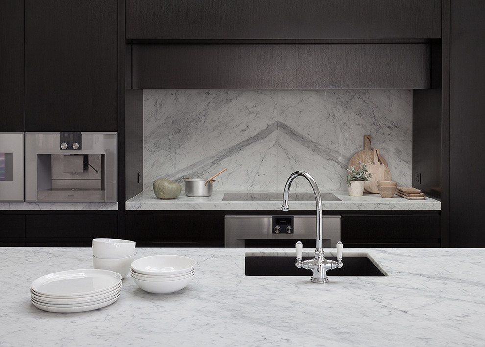Inspiration for a large traditional galley eat-in kitchen in Sydney with an undermount sink, flat-panel cabinets, black cabinets, marble benchtops, grey splashback, stone slab splashback, stainless steel appliances, with island and dark hardwood floors.