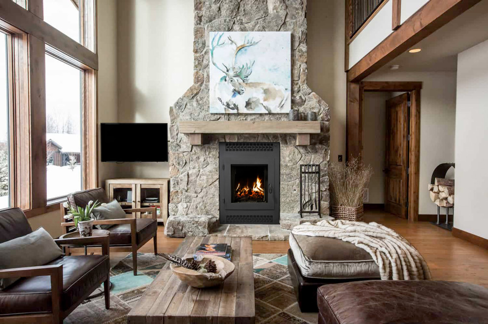 Design ideas for a large arts and crafts formal loft-style living room in Little Rock with beige walls, light hardwood floors, a standard fireplace, a stone fireplace surround, a corner tv, multi-coloured floor and vaulted.