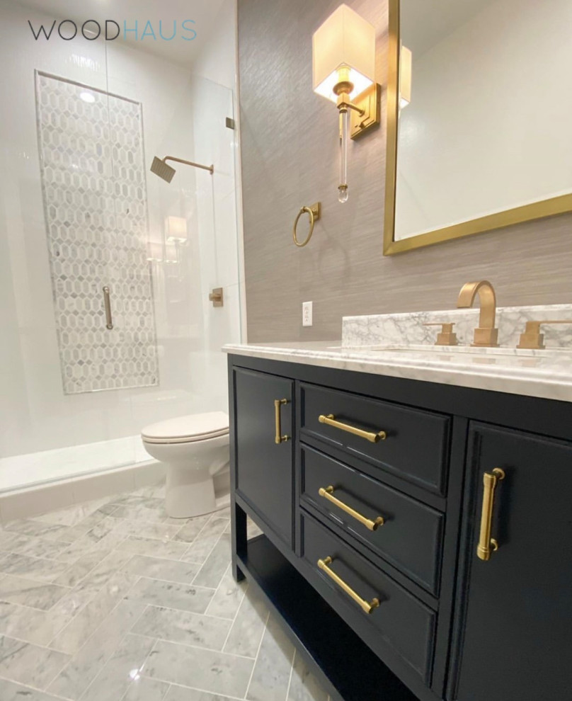 Mid-sized contemporary master bathroom in Miami with shaker cabinets, blue cabinets, an alcove shower, a two-piece toilet, white tile, porcelain tile, brown walls, marble floors, an undermount sink, marble benchtops, white floor, a hinged shower door, white benchtops, a single vanity, a freestanding vanity and wallpaper.