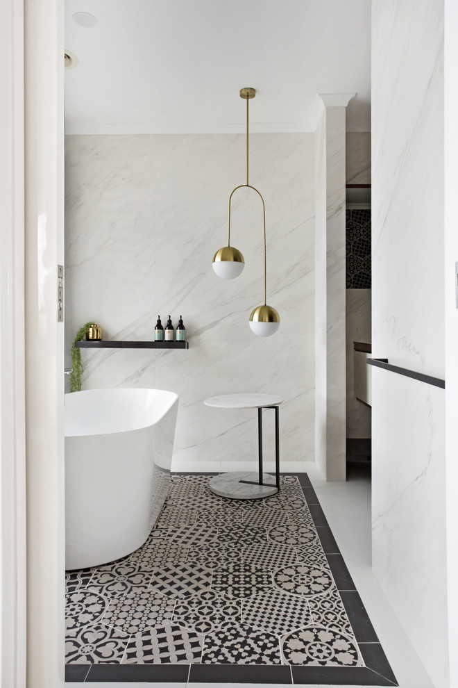 Photo of a contemporary bathroom in Geelong with a freestanding tub, white tile, white walls and multi-coloured floor.