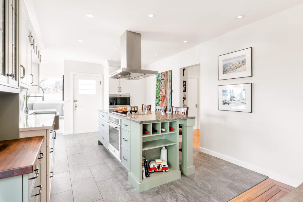 Inspiration for a mid-sized transitional galley eat-in kitchen remodel with shaker cabinets and an island