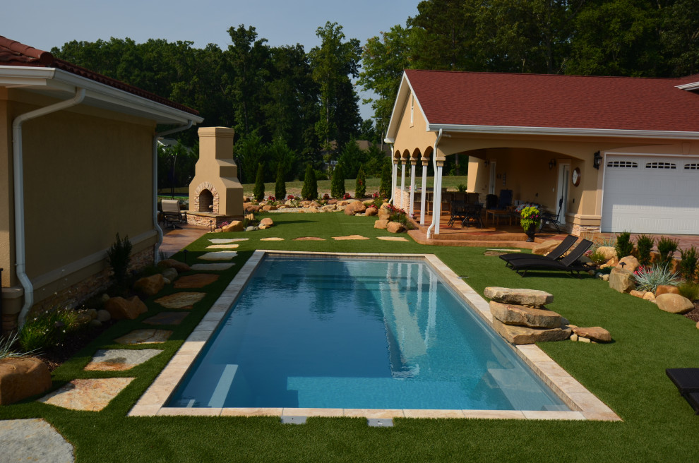 This is an example of a medium sized mediterranean back rectangular swimming pool in Other with natural stone paving.