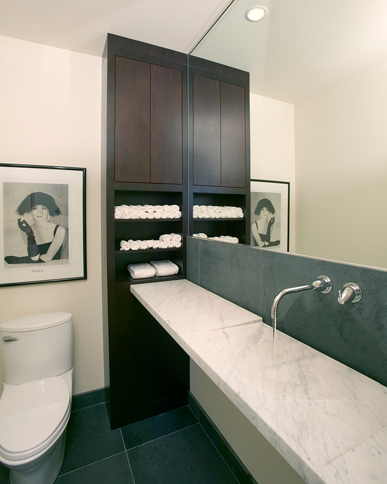 Design ideas for a mid-sized contemporary bathroom in Minneapolis with an integrated sink, flat-panel cabinets, dark wood cabinets, marble benchtops, a two-piece toilet, gray tile, stone tile, white walls and slate floors.