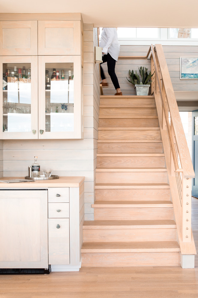 Inspiration for a mid-sized beach style wood staircase in Portland Maine with wood risers and cable railing.