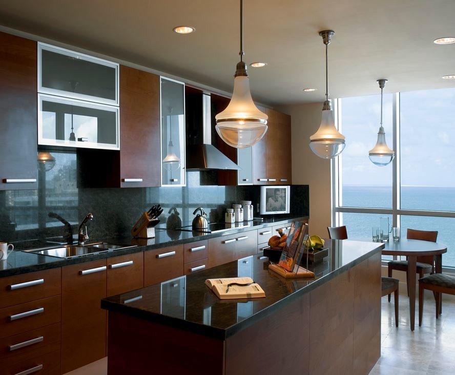 Inspiration for a large contemporary l-shaped eat-in kitchen in San Francisco with a double-bowl sink, flat-panel cabinets, dark wood cabinets, granite benchtops, black splashback, stone slab splashback, stainless steel appliances, marble floors, with island, grey floor and black benchtop.