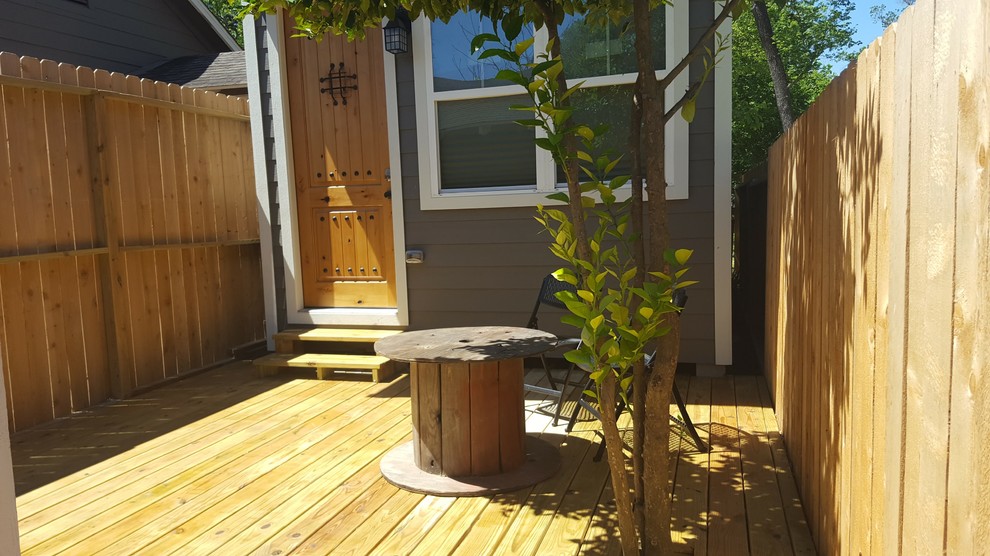 Mid-sized deck photo in Houston with a roof extension