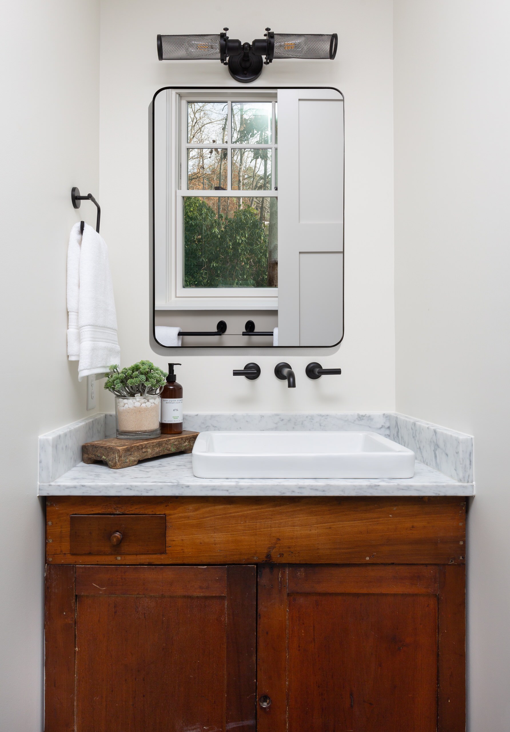 Antique cabinet repurposed to use as the vanity in the master bathroom